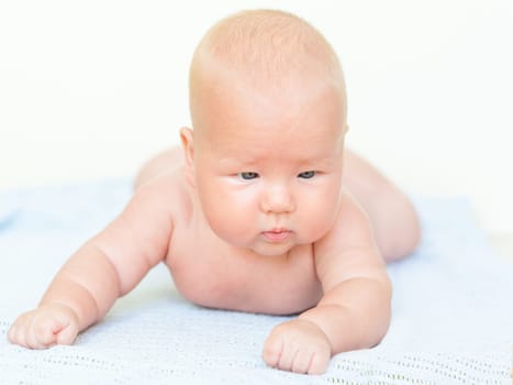 Cute baby laying on the blue towel