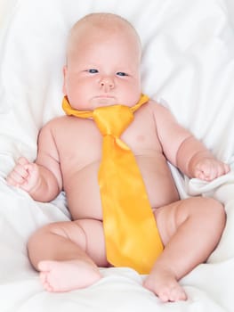 Cute baby wearing yellow tie
