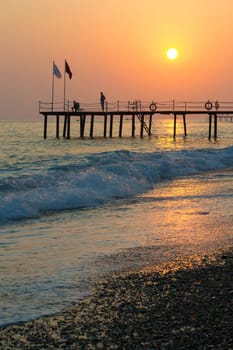 Sunset on the sea with a view of the pier
