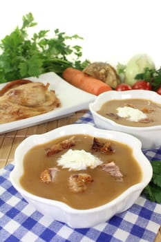 white bowls with duck soup and cream