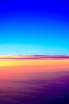 sunset with a height of 10 000 km. Dramatic sunset. View of sunset above clouds from airplane window