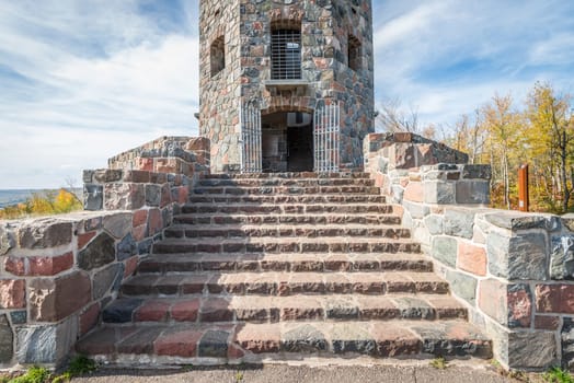 Front entrace of a stone tower during autumn time