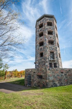 Stone tower in middle of a public park during autumn