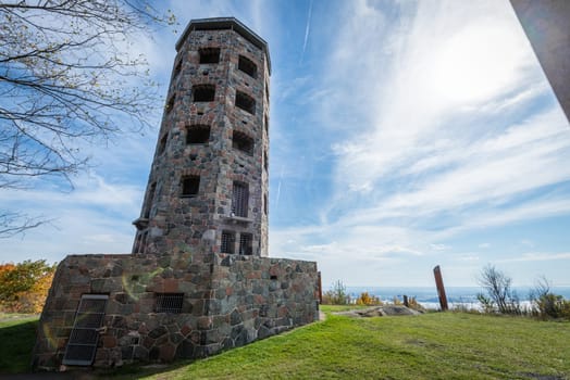 Stone tower in middle of a public park during autumn