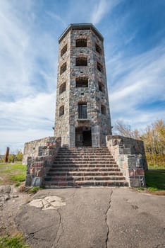 Front entrace of a stone tower during autumn time