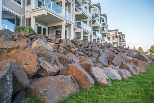 Rock piles in front of a building of luxury appartments