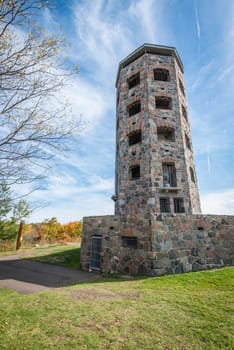 Stone tower in middle of a public park during autumn