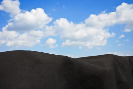 Black tarpaulin with sky and clouds