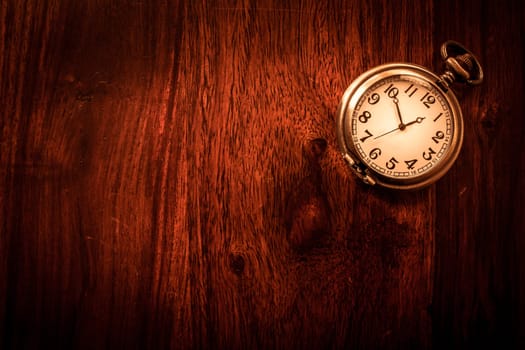Vintage pocket watch on solid wood