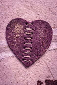 Romantic purple heart on a rough surface