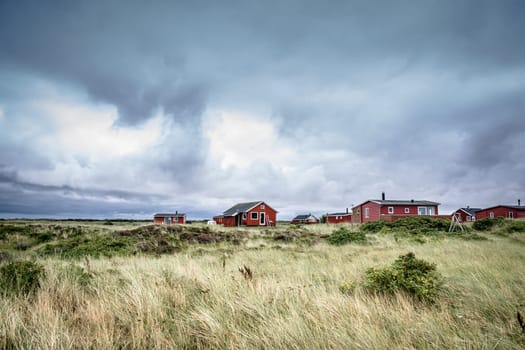 Scandinavian summer cabins in stormy weather