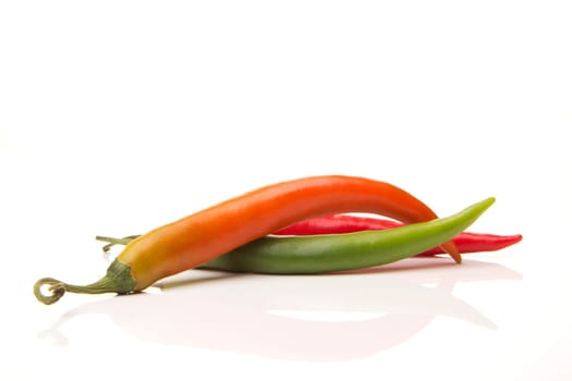 several red,yellow and green peppers with white background