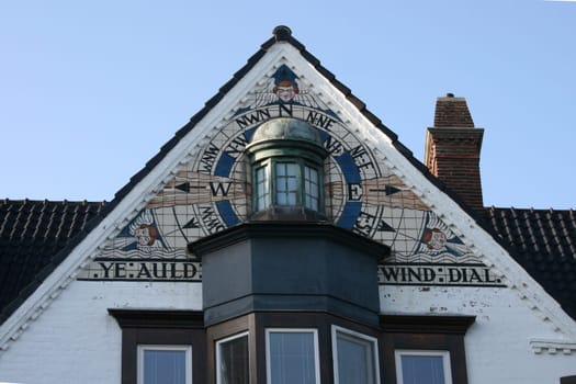 House with a wind rose painted on the façade