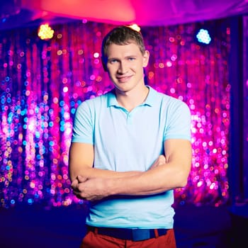Portrait of smiling guy looking at camera at party