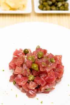 Raw tuna tartare with capers in portrait format
