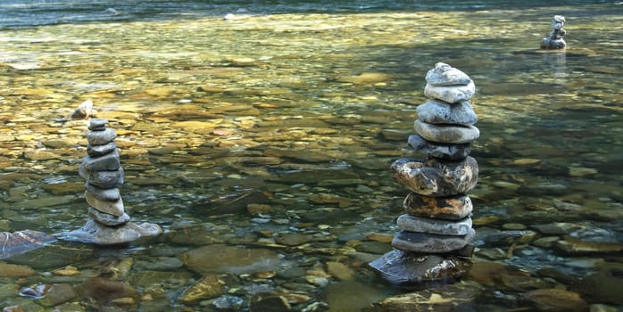 Three stone men in a river