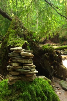 Stone man on a stone with moss