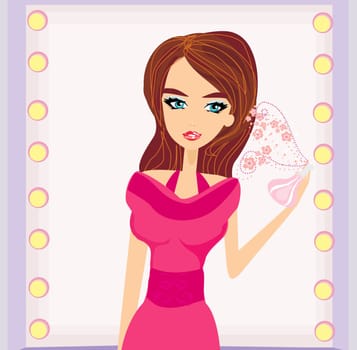 young woman spraying perfume on herself