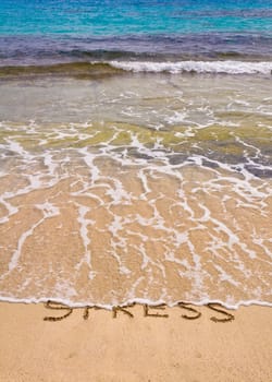 Words Stress written on sand, washed away by waves, relax concept