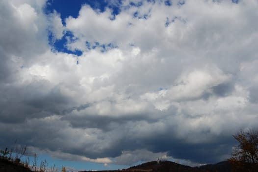 church on hill with stormy clouds