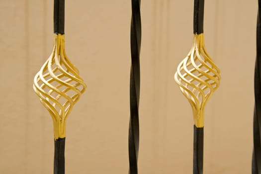Bulbous  design of gold-painted iron barricade rods
