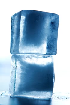 two ice cubes stacked with colored background