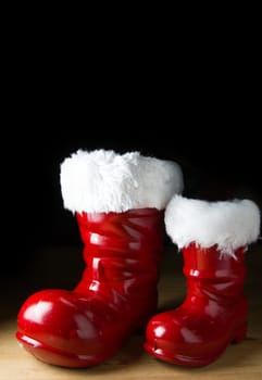 Red Santa boot and gifts on black background