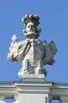 Imaginative statue made of grey stone,with blue sky in the background
