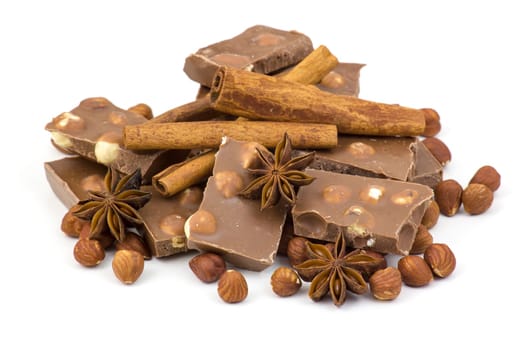 chocolate, spices and nuts on white background
