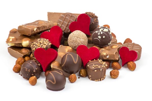 delicious chocolate and hearts on white background
