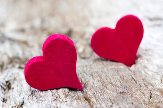 two red hearts on wooden background