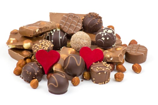 delicious chocolate and hearts on white background