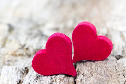 two red hearts on wooden background