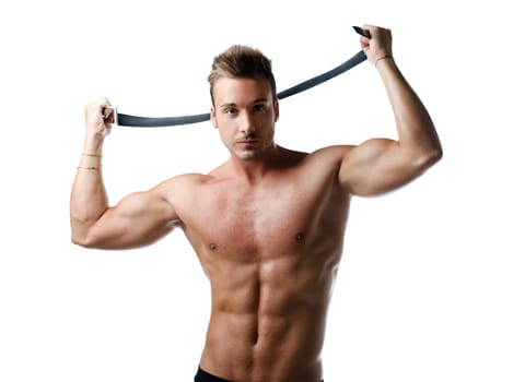 Attractive young muscle man naked playing with black belt, isolated on white