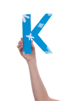 A Hand Holding the Blue and Snowy Letter K, Isolated