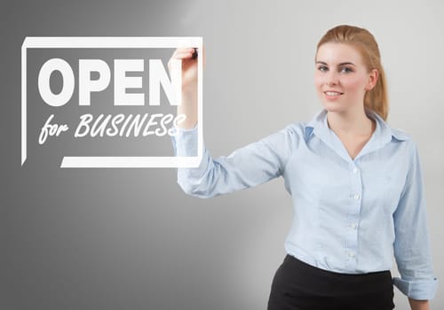 open for business sign hand drawn on to the screen by businesswoman