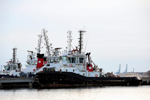 Tug boats with quay for the evening in a creek of Fos on Sea beside Marseille.