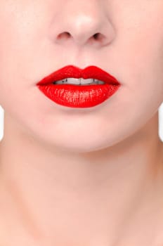 The seductive mouth and neck of a pretty young woman. The mouth is slightly open,you can see her beautiful white teeth.