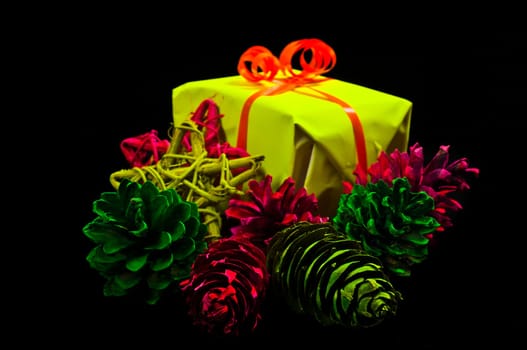 Gifts,Christmas baubles and stars in neon colors on black background