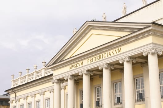 The Fridericianum is a museum building in Kassel,Germany. Completed in 1779,the building served from the outset as one of the first public museums on the European continent for the art objects collected by the Hessian landgraves and housed the princely library. In the Kingdom of Westphalia,the Fridericianum was from 1810 to 1813 Estates Palace with Parliament Hall. Today,the Fridericianum becomes the center of documenta every five years and is an exhibition venue for contemporary art,the "Kunsthalle Fridericianum""... The building is located on Friedrichsplatz between the former old town and the Oberneustadt."