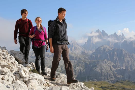 Young people hike in the mountains Alps Dolomites
