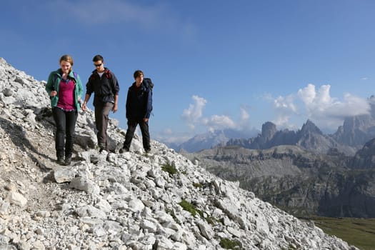 A group of young people on a hike in the mountains Alps Dolomites