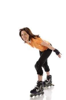 Adult woman has fun with inline skating in front of a white background