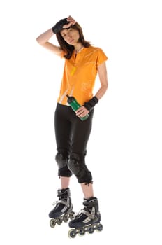 Adult woman does sports on inline skates and drinks from her water bottle against a white background