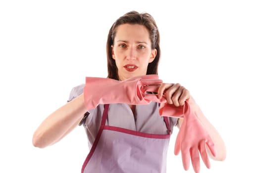 Housewife,cleaning lady with long dark blond hair and kitchen apron doing housework against a white background.