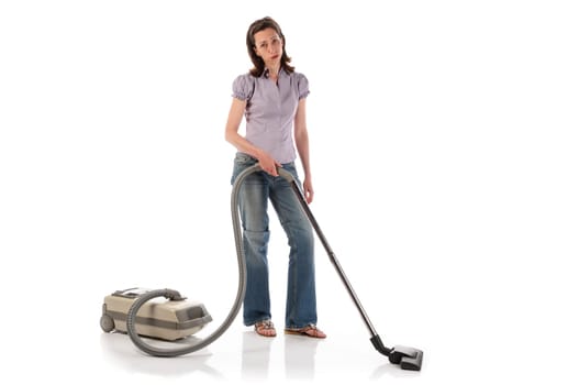Housewife,cleaning lady with long dark blond hair and kitchen apron doing housework against a white background.