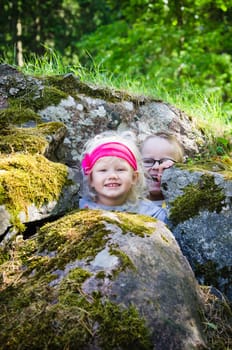 Young children, the boy with the girl hid among the rocks