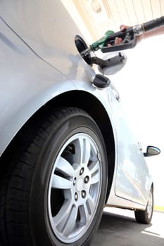 Petrol or gasoline being pumped into a motor vehicle car