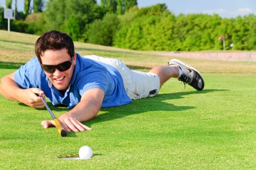 Young men play golf