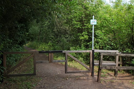 Forest path with vehicle barrier